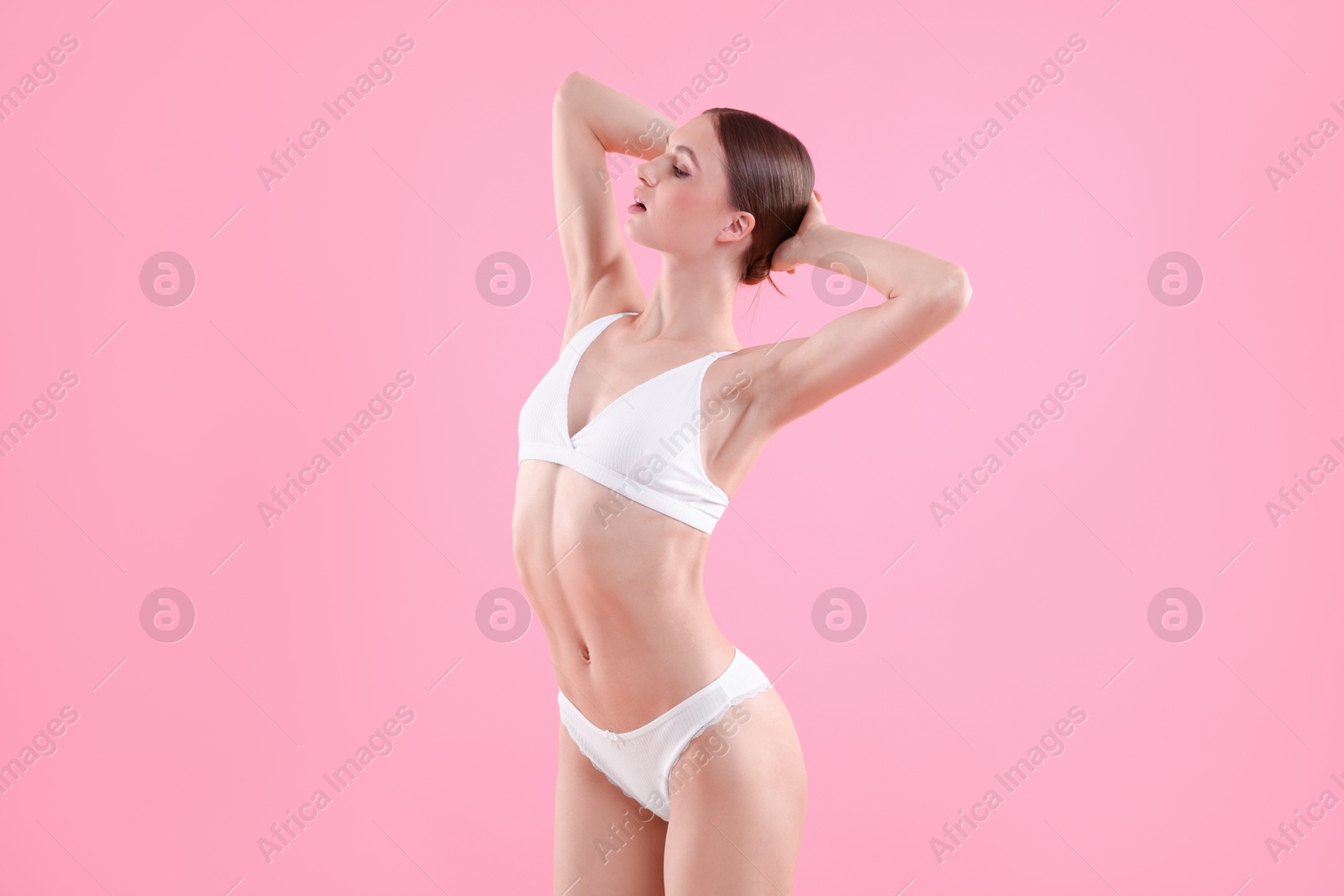 Woman wearing beautiful underwear on pink background Photo of Woman wearing beautiful underwear on pink background
