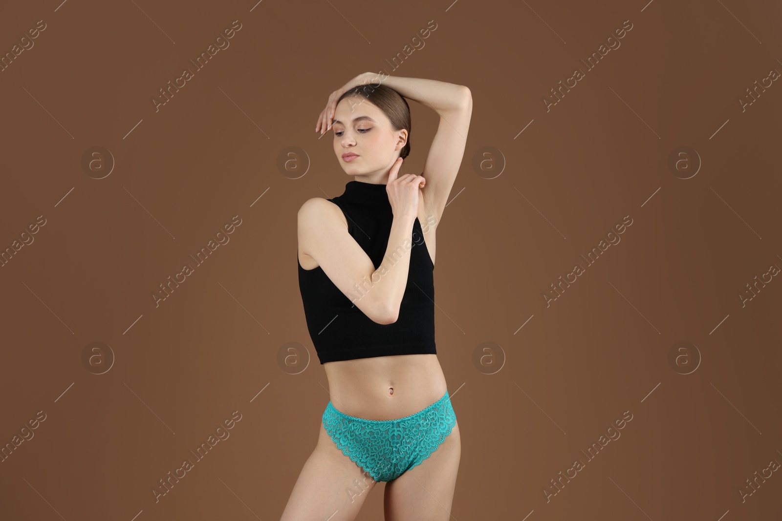 Woman wearing beautiful underwear on brown background Photo of Woman wearing beautiful underwear on brown background