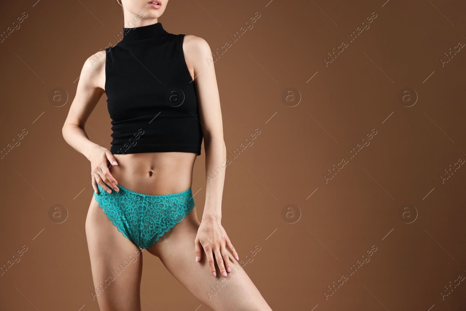 Woman wearing beautiful underwear on brown background, closeup. Space for text Photo of Woman wearing beautiful underwear on brown background, closeup. Space for text