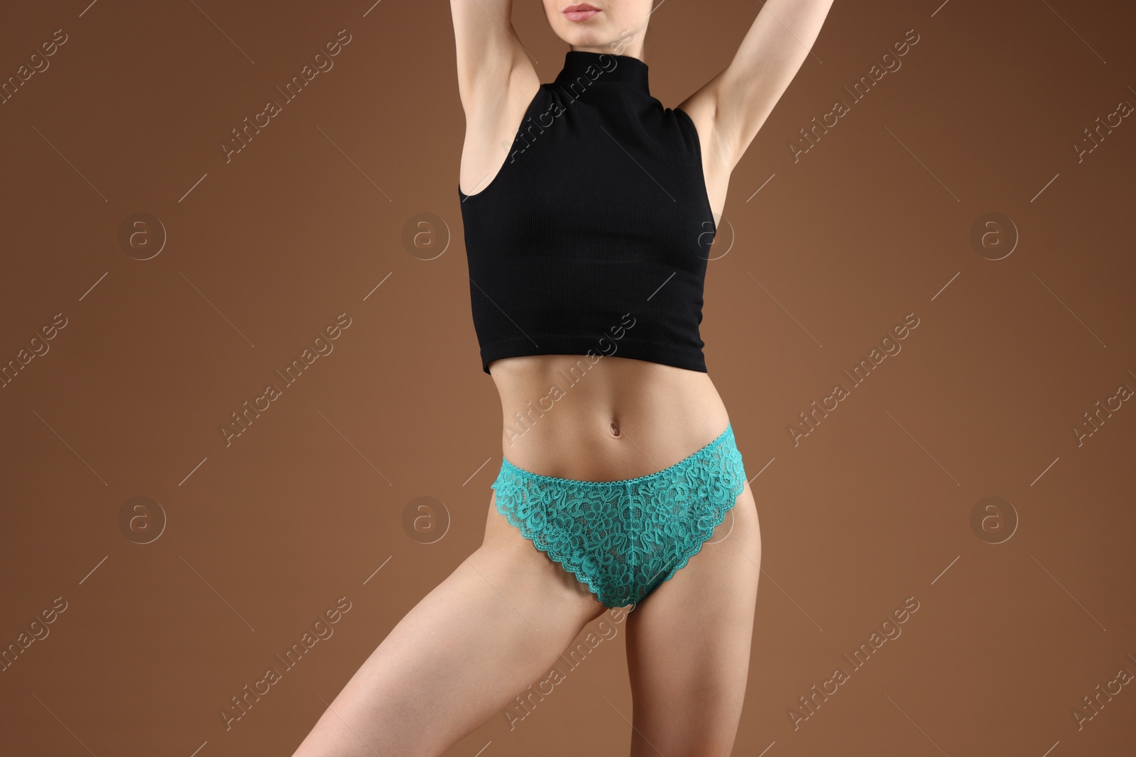 Woman wearing beautiful underwear on brown background, closeup Photo of Woman wearing beautiful underwear on brown background, closeup