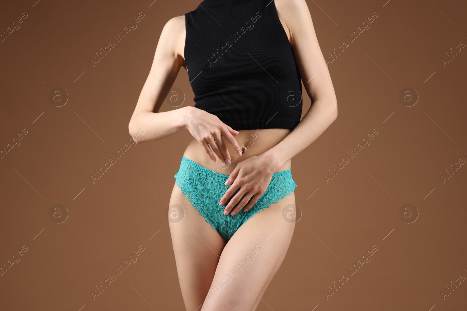 Woman wearing beautiful underwear on brown background, closeup Photo of Woman wearing beautiful underwear on brown background, closeup