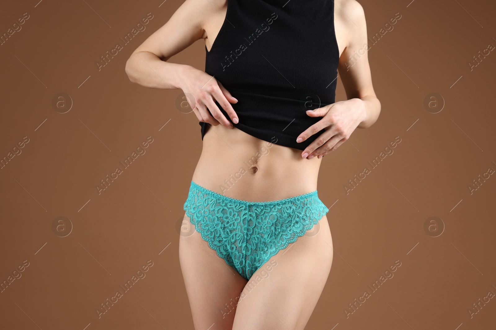 Woman wearing beautiful underwear on brown background, closeup Photo of Woman wearing beautiful underwear on brown background, closeup