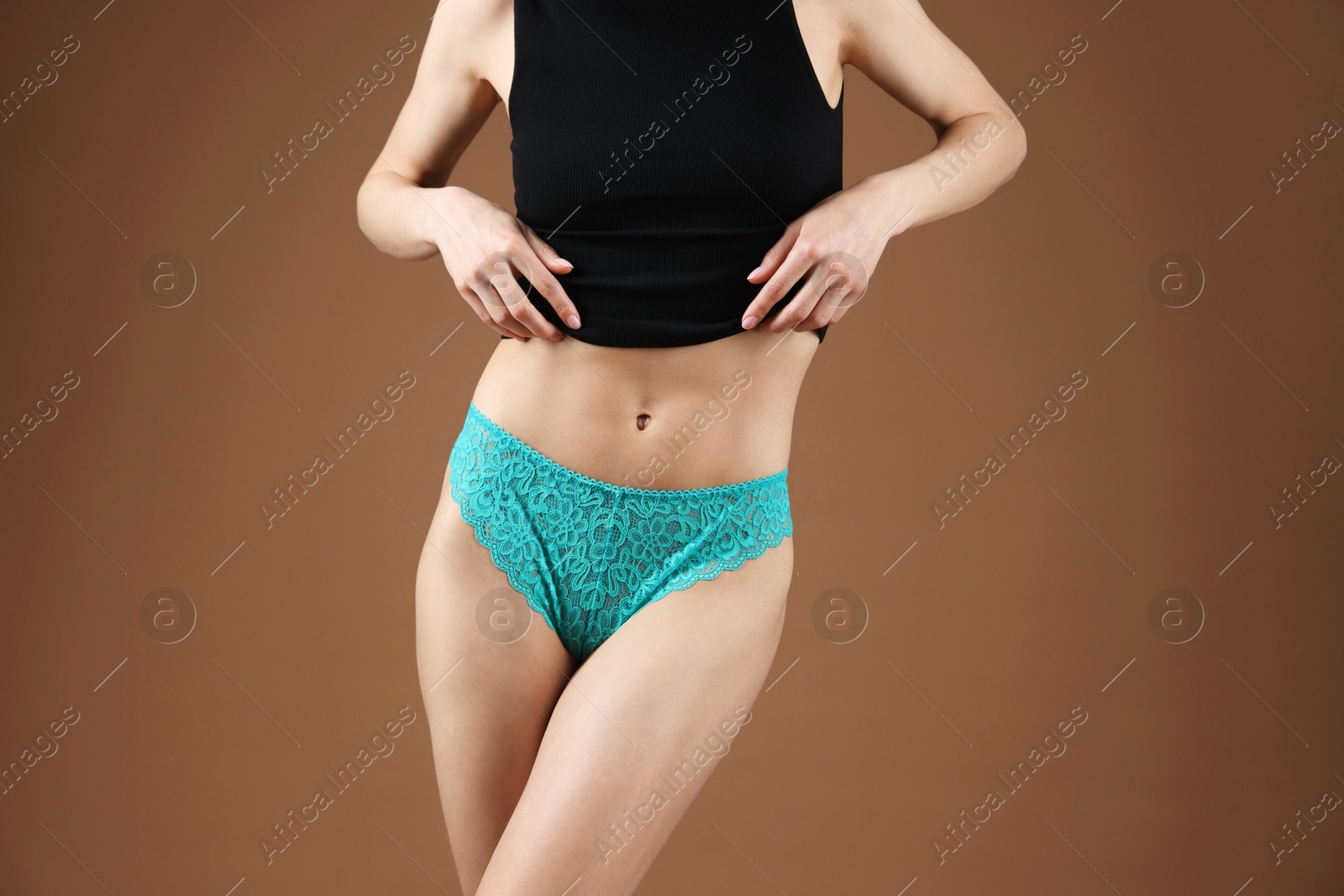 Woman wearing beautiful underwear on brown background, closeup Photo of Woman wearing beautiful underwear on brown background, closeup
