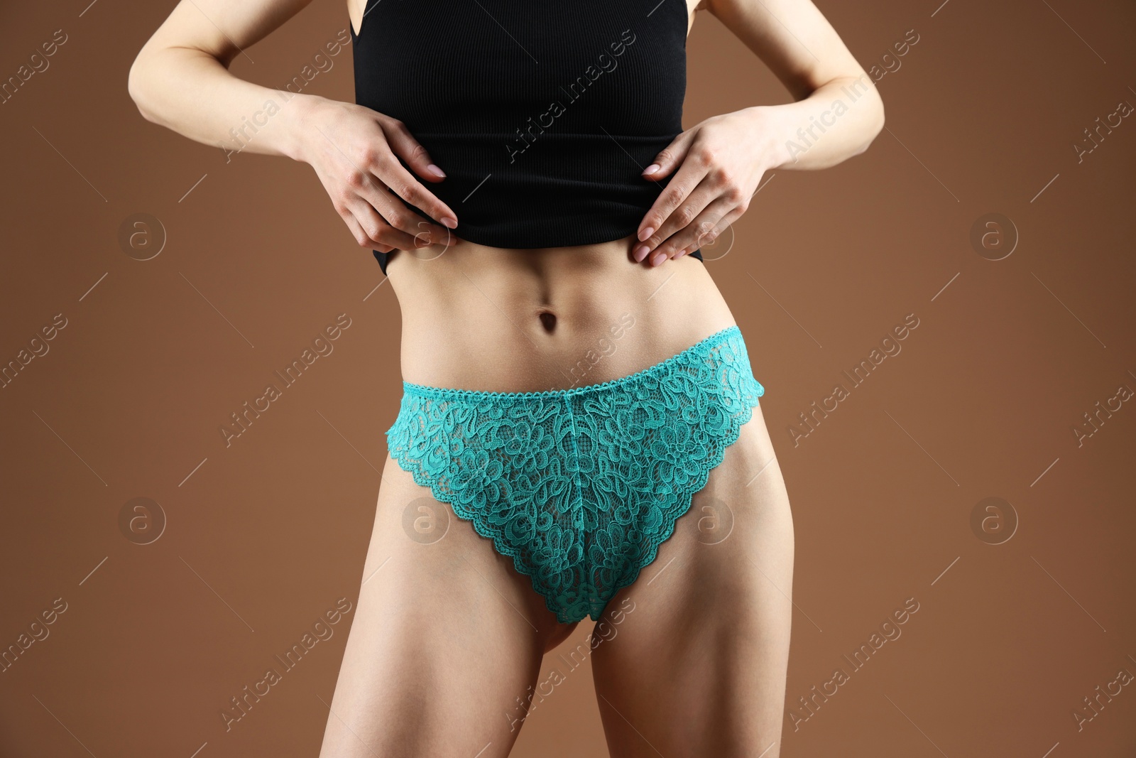 Woman wearing beautiful underwear on brown background, closeup Photo of Woman wearing beautiful underwear on brown background, closeup