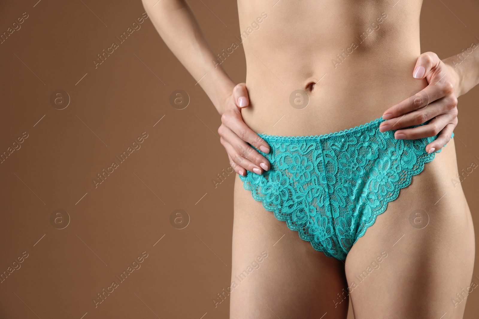 Woman wearing beautiful underwear on brown background, closeup. Space for text Photo of Woman wearing beautiful underwear on brown background, closeup. Space for text