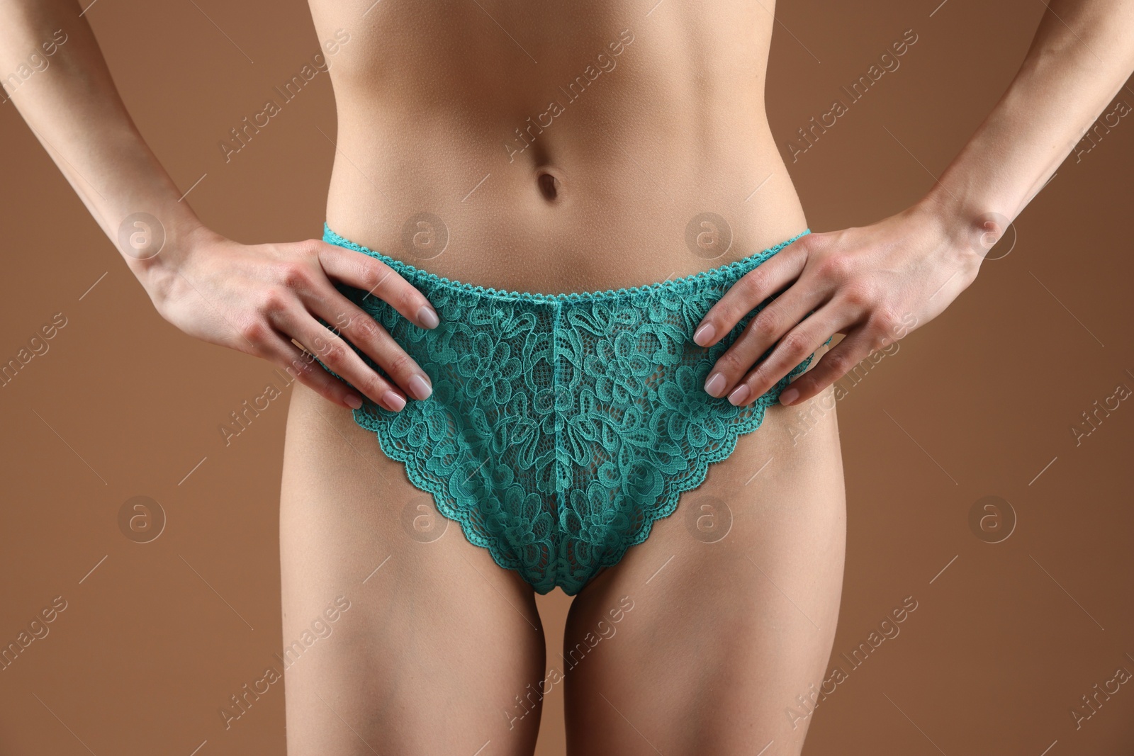 Woman wearing beautiful underwear on brown background, closeup Photo of Woman wearing beautiful underwear on brown background, closeup