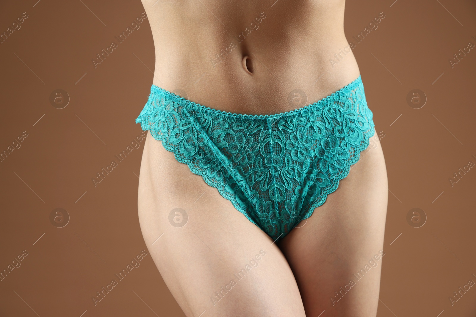 Woman wearing beautiful underwear on brown background, closeup Photo of Woman wearing beautiful underwear on brown background, closeup