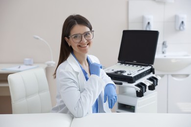 Photo of Professional sonographer with ultrasound machine in clinic