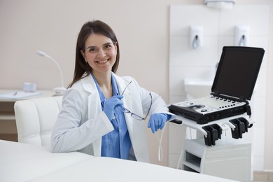 Photo of Professional sonographer with ultrasound machine in clinic