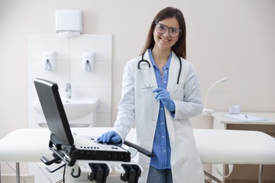 Photo of Professional sonographer with ultrasound machine in clinic