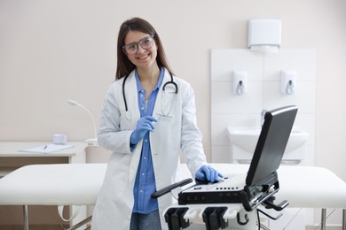 Photo of Professional sonographer with ultrasound machine in clinic