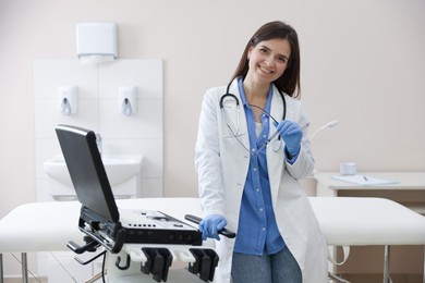 Photo of Professional sonographer with ultrasound machine in clinic