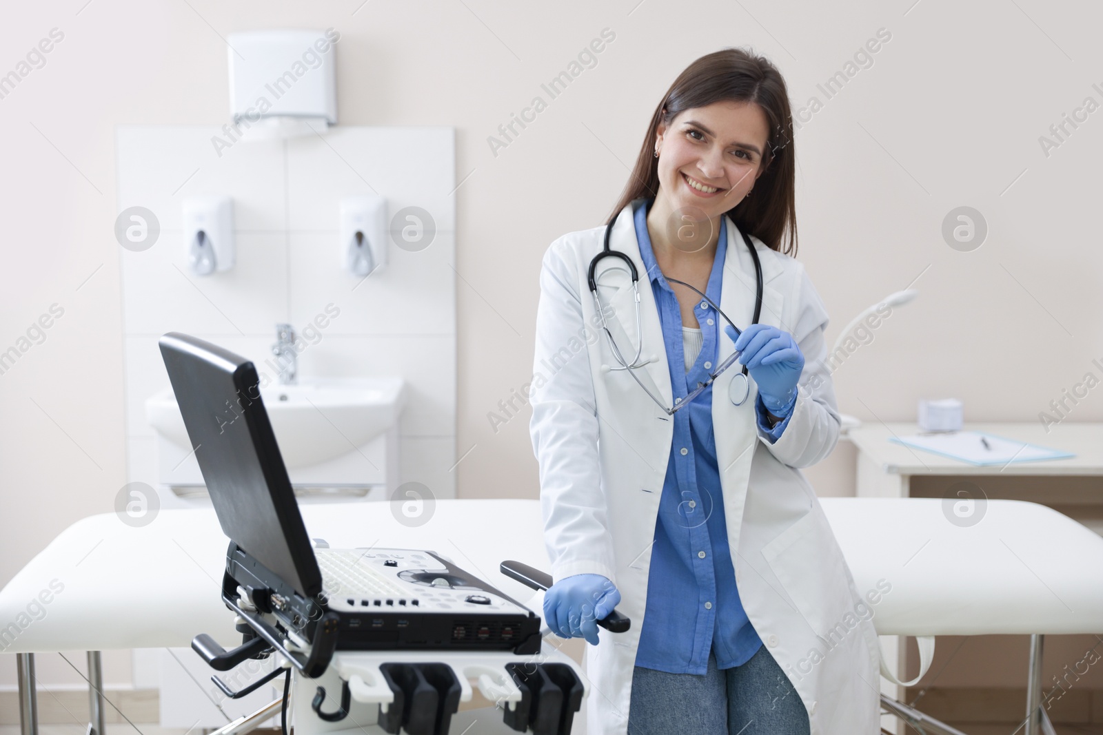 Professional sonographer with ultrasound machine in clinic Photo of Professional sonographer with ultrasound machine in clinic