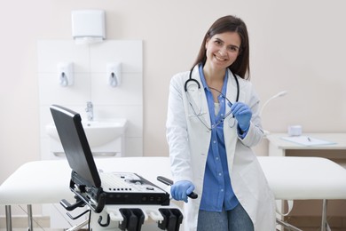 Photo of Professional sonographer with ultrasound machine in clinic