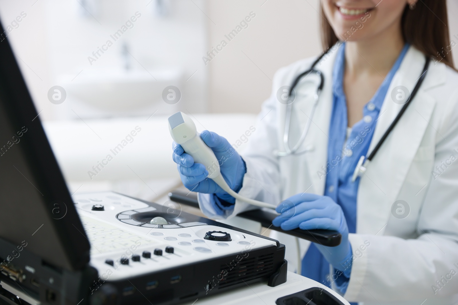 Professional sonographer with ultrasound machine in clinic, closeup Photo of Professional sonographer with ultrasound machine in clinic, closeup