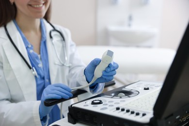 Photo of Professional sonographer with ultrasound machine in clinic, closeup