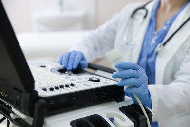 Photo of Professional sonographer with ultrasound machine in clinic, closeup