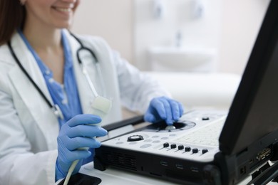 Photo of Professional sonographer with ultrasound machine in clinic, closeup