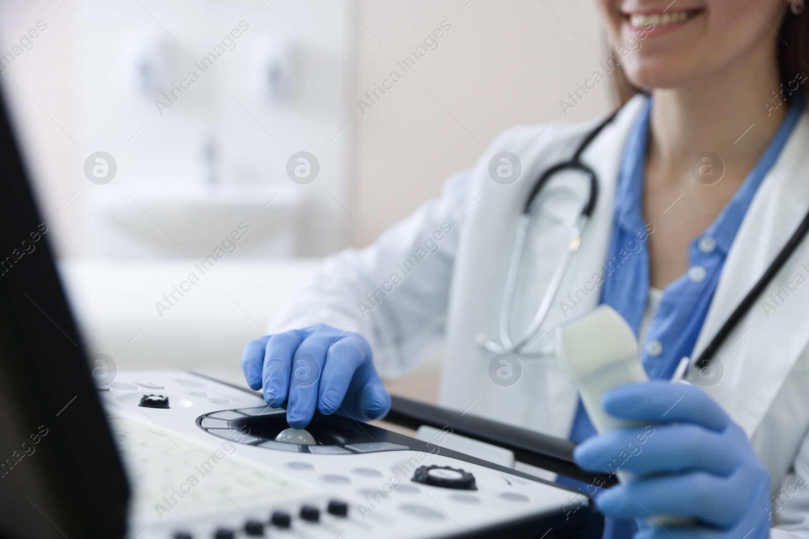 Professional sonographer with ultrasound machine in clinic, closeup Photo of Professional sonographer with ultrasound machine in clinic, closeup