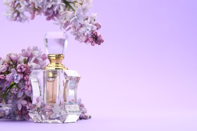 Photo of Bottle with perfume and lilac flowers on violet gradient background, closeup. Space for text