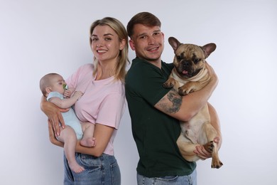 Photo of Happy family with little baby and cute dog on white background