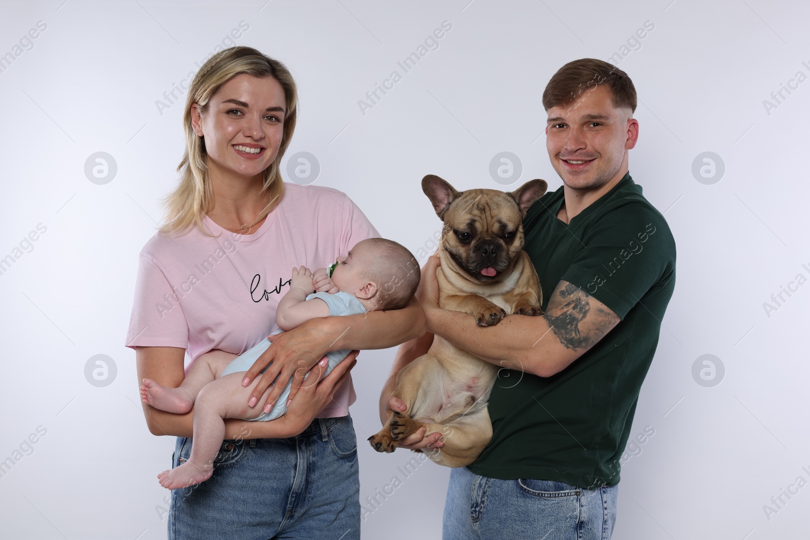 Happy family with little baby and cute dog on white background Photo of Happy family with little baby and cute dog on white background
