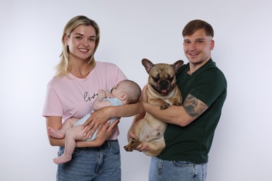 Photo of Happy family with little baby and cute dog on white background