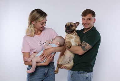 Photo of Happy family with little baby and cute dog on white background
