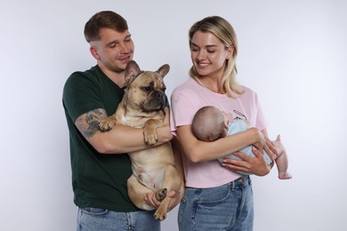 Photo of Happy family with little baby and cute dog on white background
