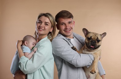 Photo of Happy family with little baby and cute dog on beige background