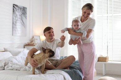 Photo of Happy family with little baby and cute dog at home