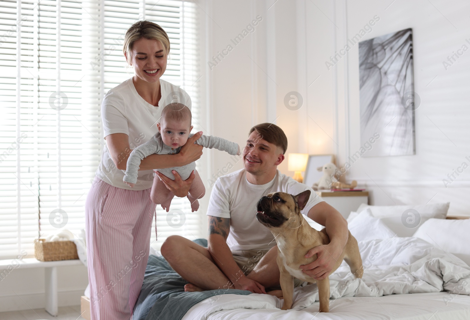 Happy family with little baby and cute dog at home Photo of Happy family with little baby and cute dog at home