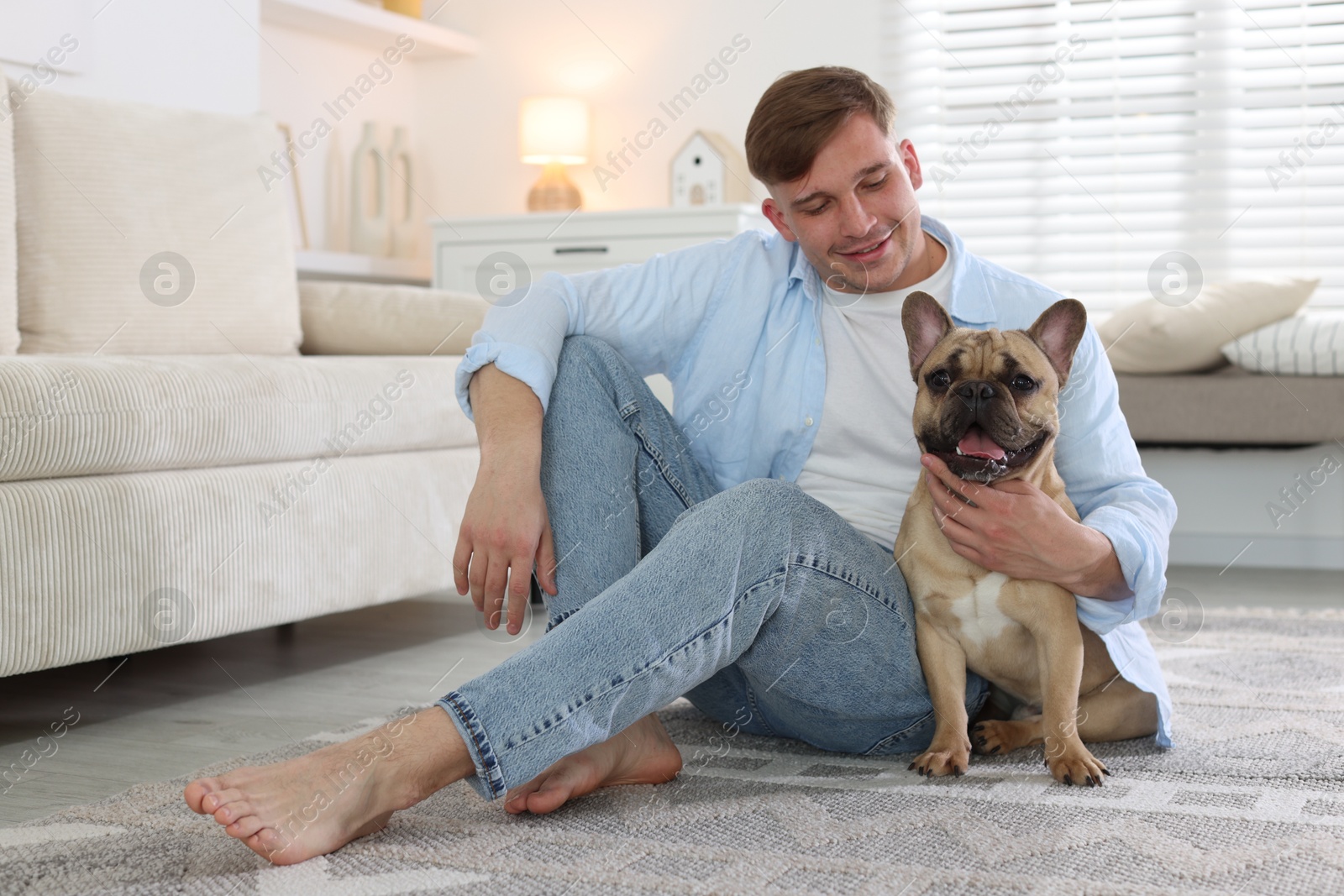 Man and his cute dog at home Photo of Man and his cute dog at home