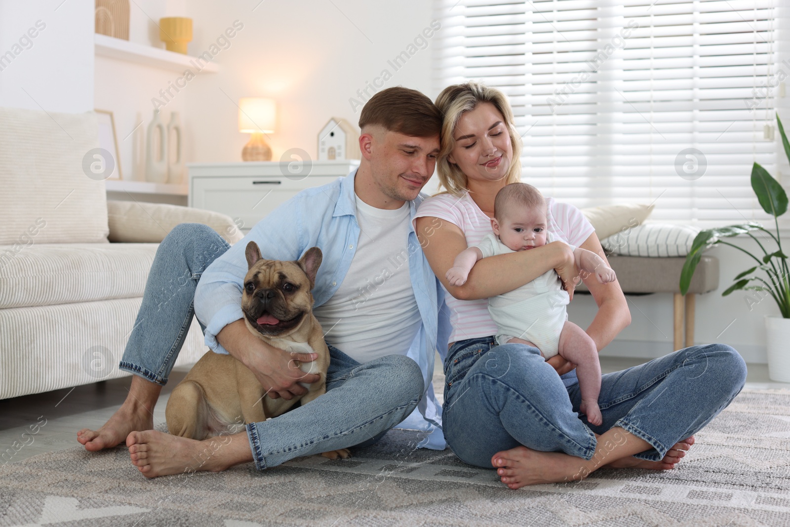 Happy family with little baby and cute dog at home Photo of Happy family with little baby and cute dog at home