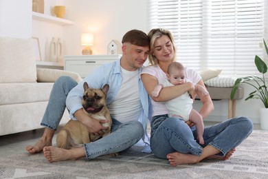 Photo of Happy family with little baby and cute dog at home