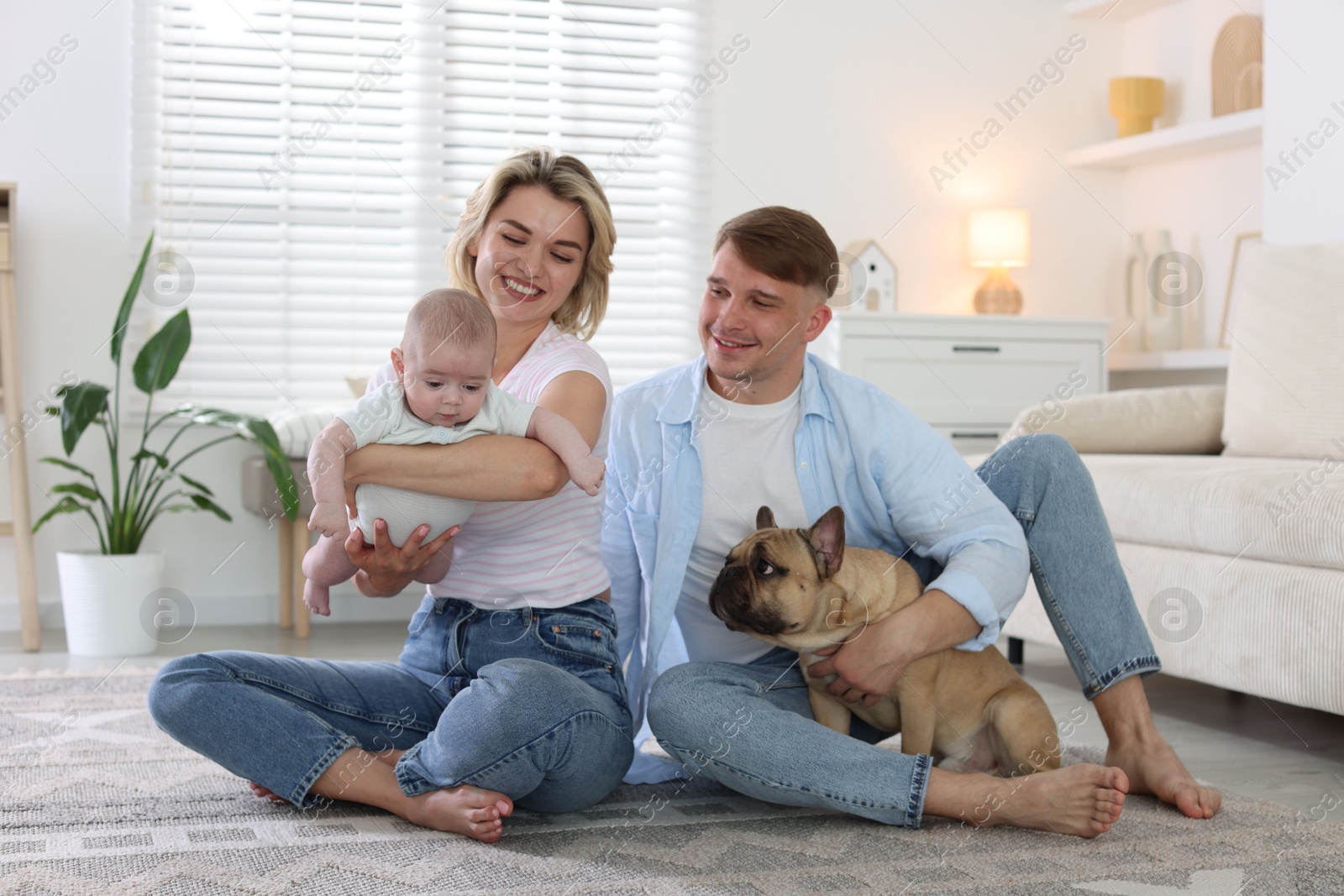 Happy family with little baby and cute dog at home Photo of Happy family with little baby and cute dog at home