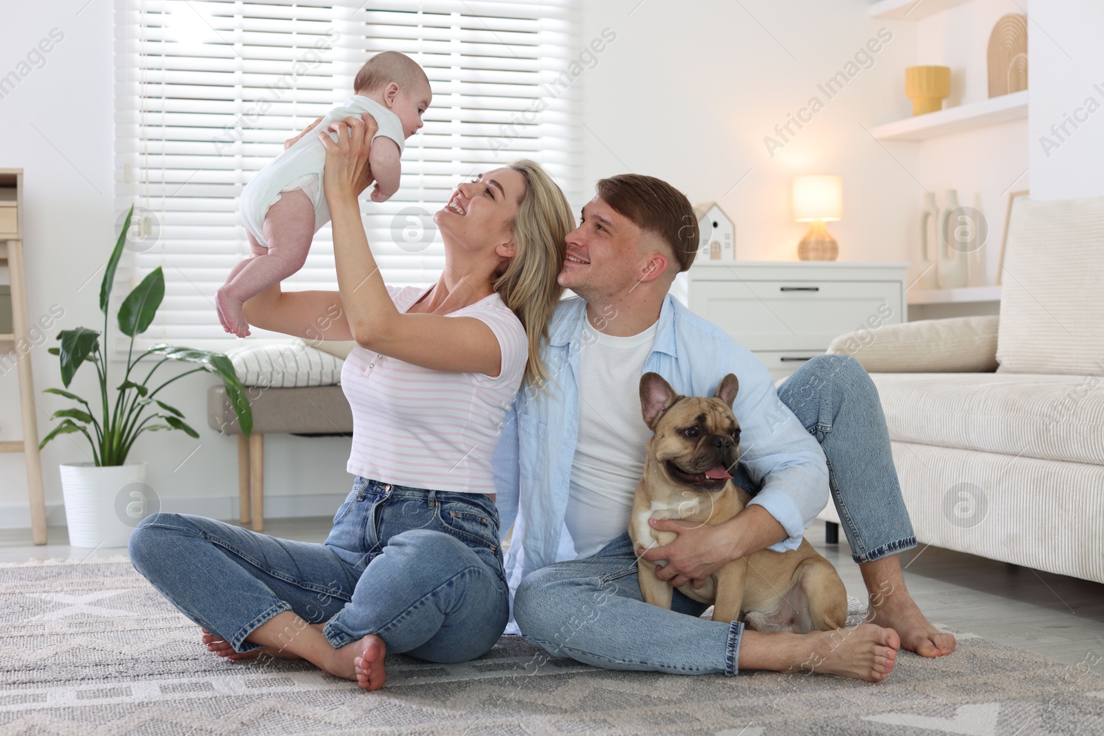 Happy family with little baby and cute dog at home Photo of Happy family with little baby and cute dog at home