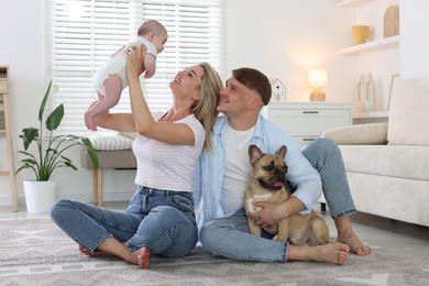Photo of Happy family with little baby and cute dog at home