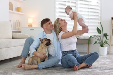 Photo of Happy family with little baby and cute dog at home