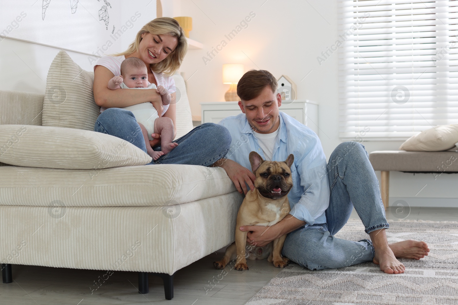 Happy family with little baby and cute dog at home Photo of Happy family with little baby and cute dog at home