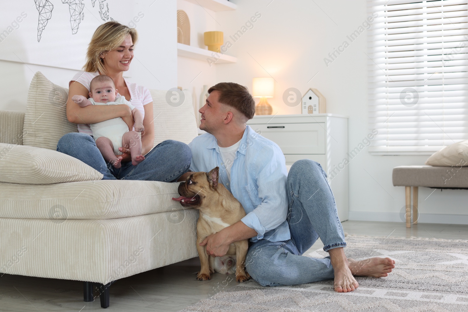 Happy family with little baby and cute dog at home. Space for text Photo of Happy family with little baby and cute dog at home. Space for text