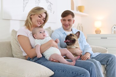 Photo of Happy family with little baby and cute dog on sofa at home