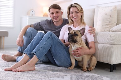Photo of Happy couple with cute dog at home