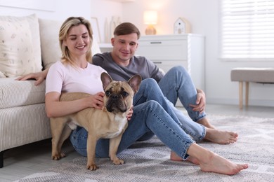 Photo of Happy couple with cute dog at home