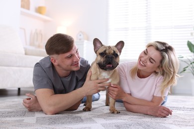 Photo of Happy couple with cute dog at home
