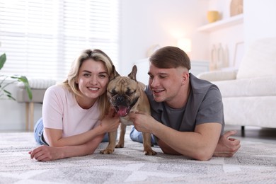 Photo of Happy couple with cute dog at home