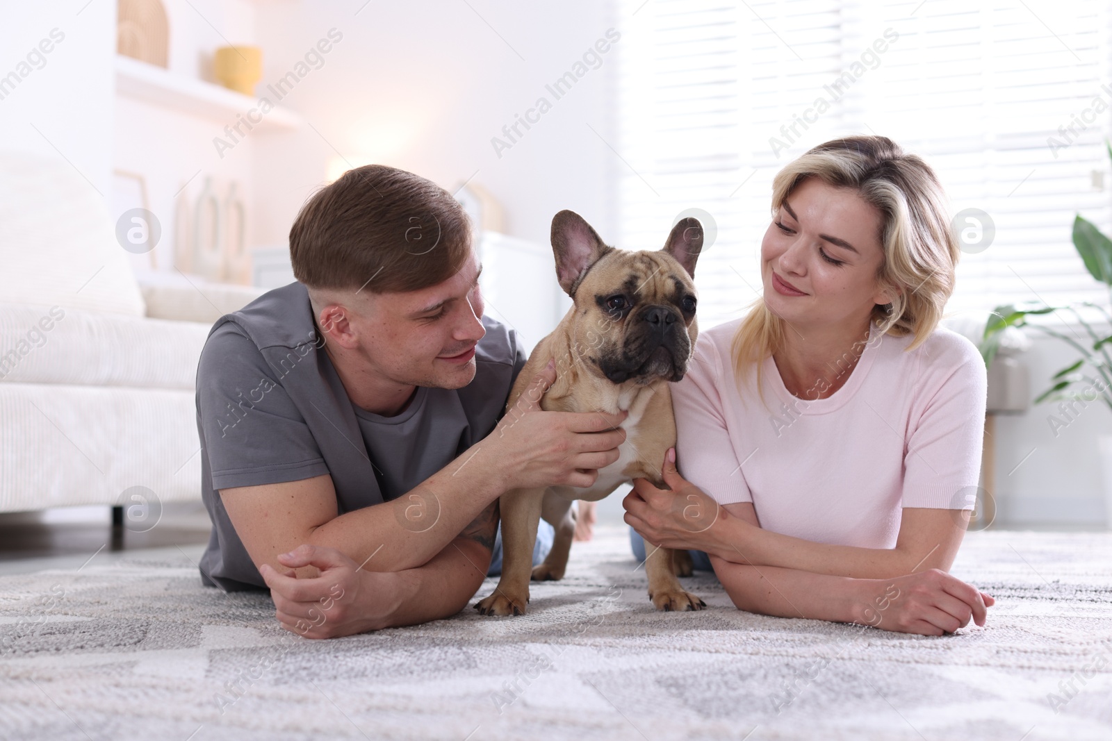 Happy couple with cute dog at home Photo of Happy couple with cute dog at home