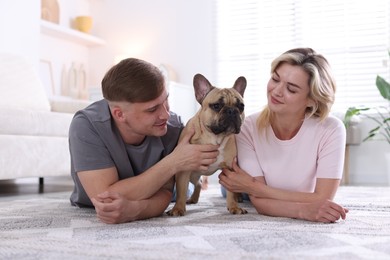 Photo of Happy couple with cute dog at home