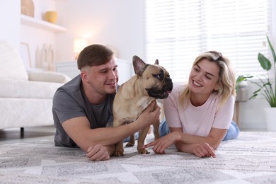 Photo of Happy couple with cute dog at home