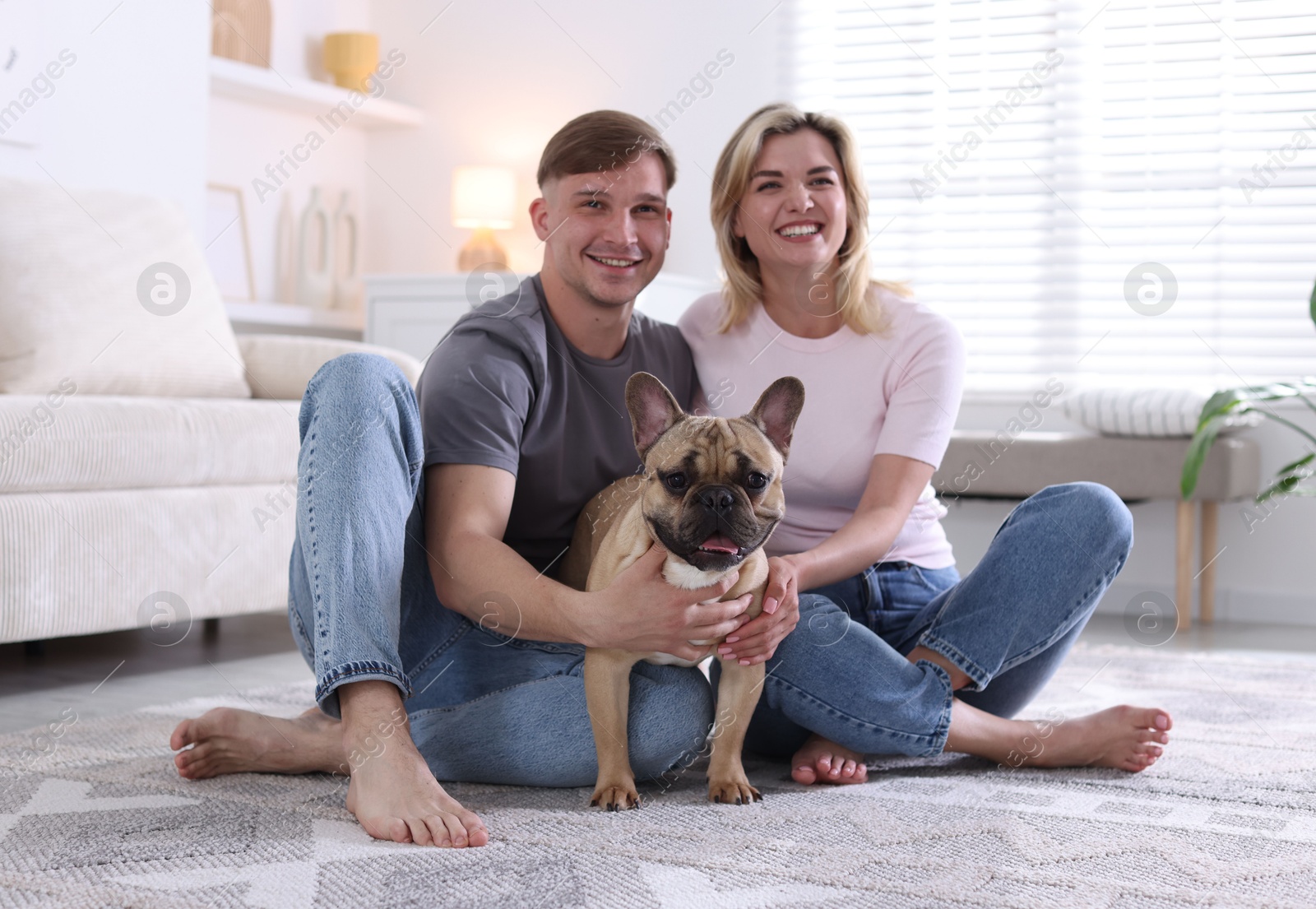 Happy couple with cute dog at home Photo of Happy couple with cute dog at home